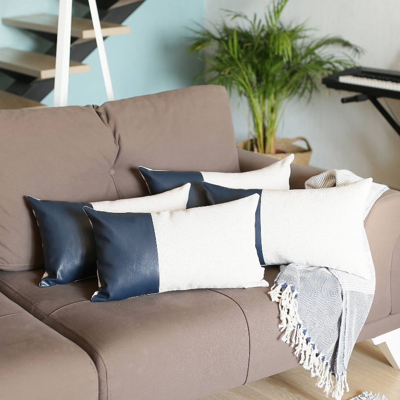 Set of 4 decorative pillows featuring cream panels bordered by dark blue