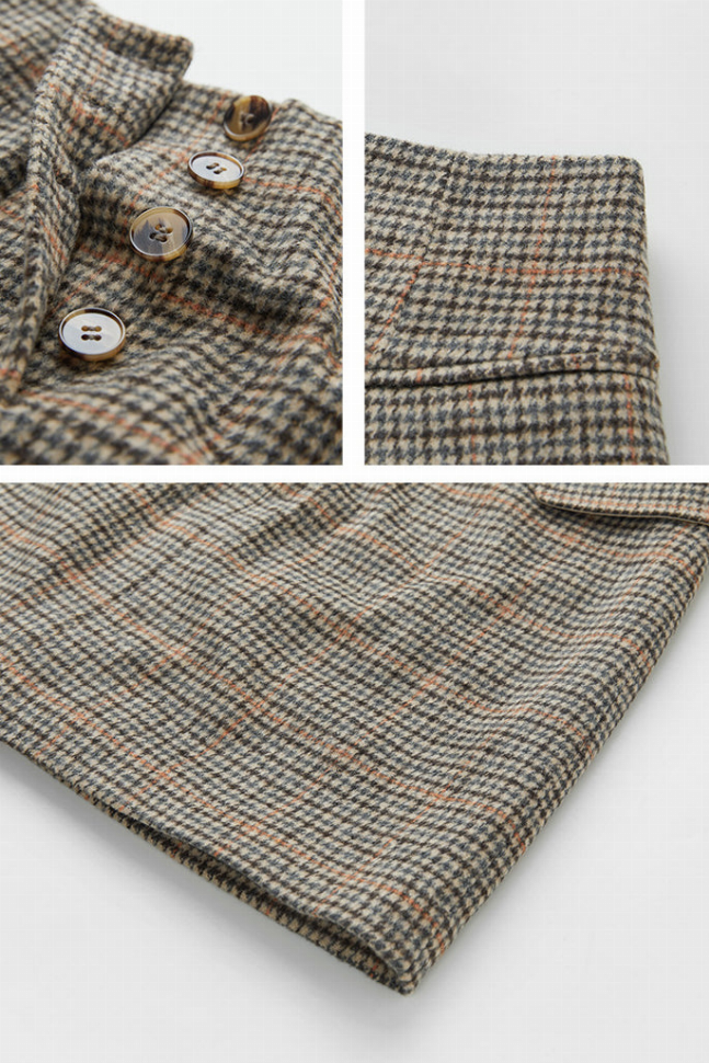 Checked skirt close-up: button placket with round buttons on folded waist