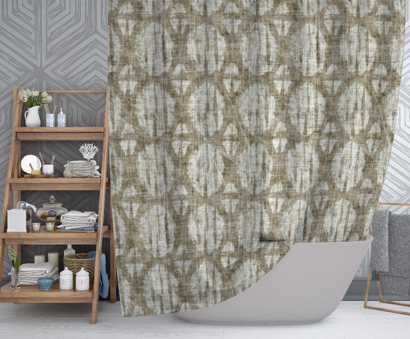 Beige shower curtain with abstract geometric pattern and curved hem over white bathtub