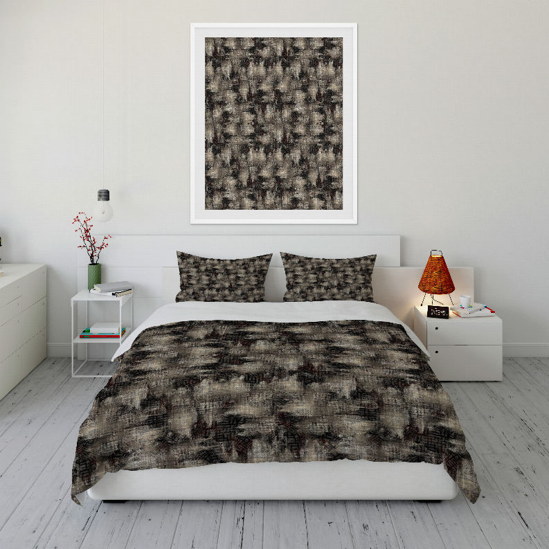 Comforter set on white bedframe, dark gray and black abstract patterned quilt and shams