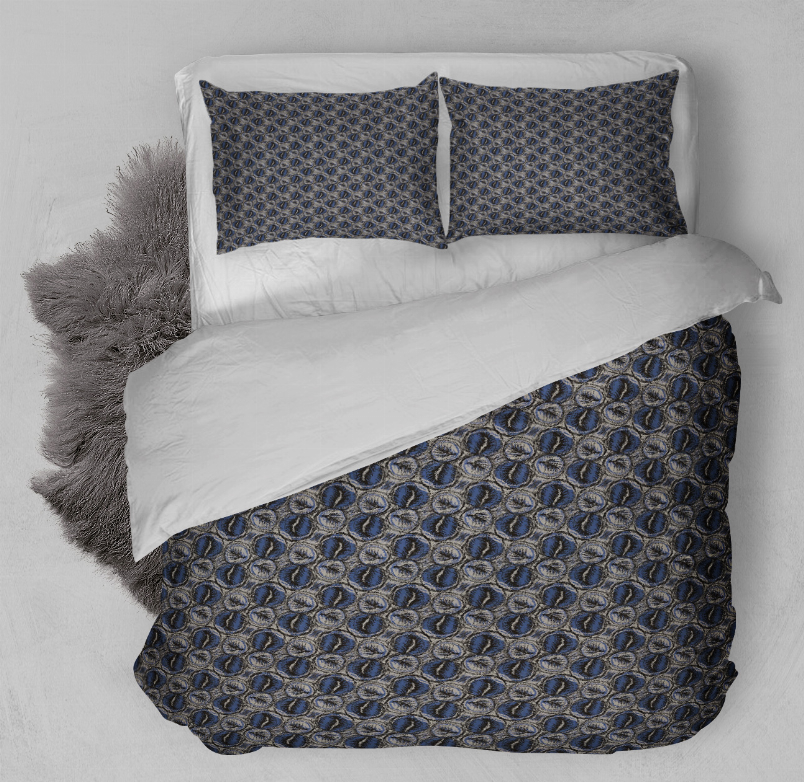 Navy blue patterned duvet cover set with two pillow shams on bed