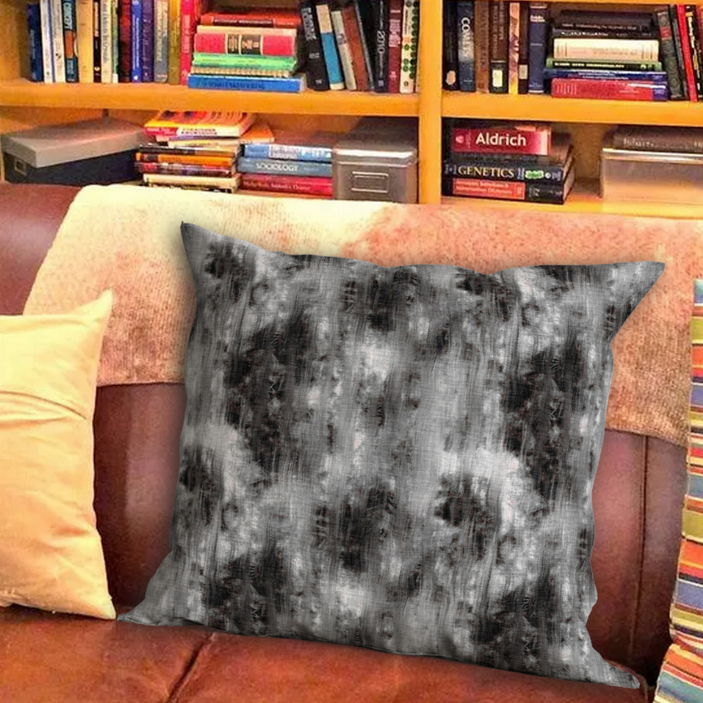 Square throw pillow with mottled charcoal-gray abstract pattern