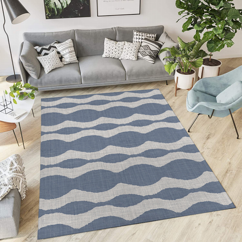 Low pile area rug with blue and white wavy stripe pattern, rectangular