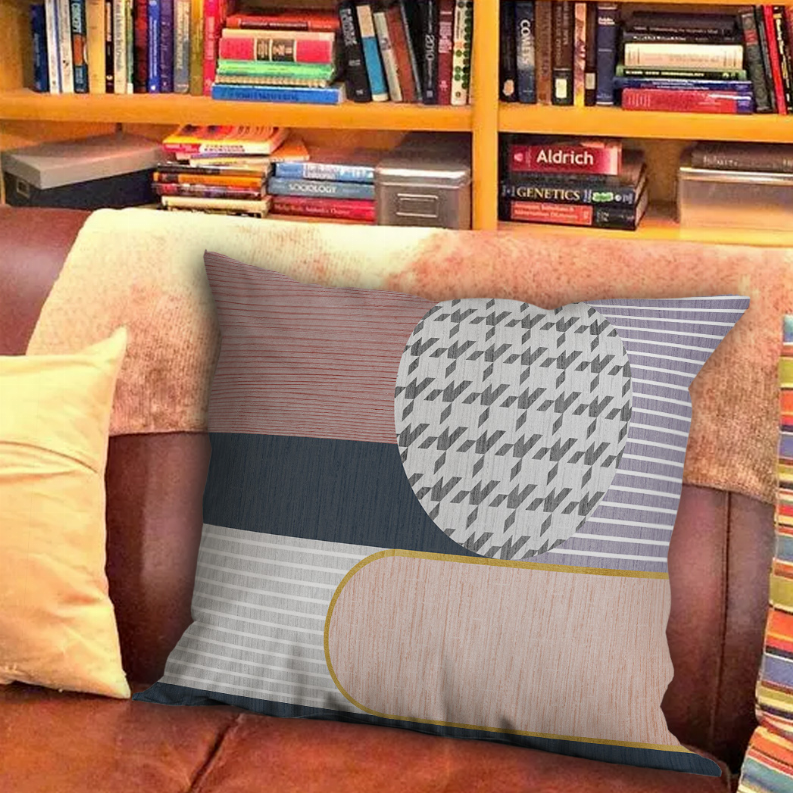 Multicolor pillow with striped panels and a textured circular motif, on armchair