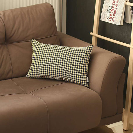 Houndstooth jacquard throw pillow on brown couch, black-and-yellow grid pattern