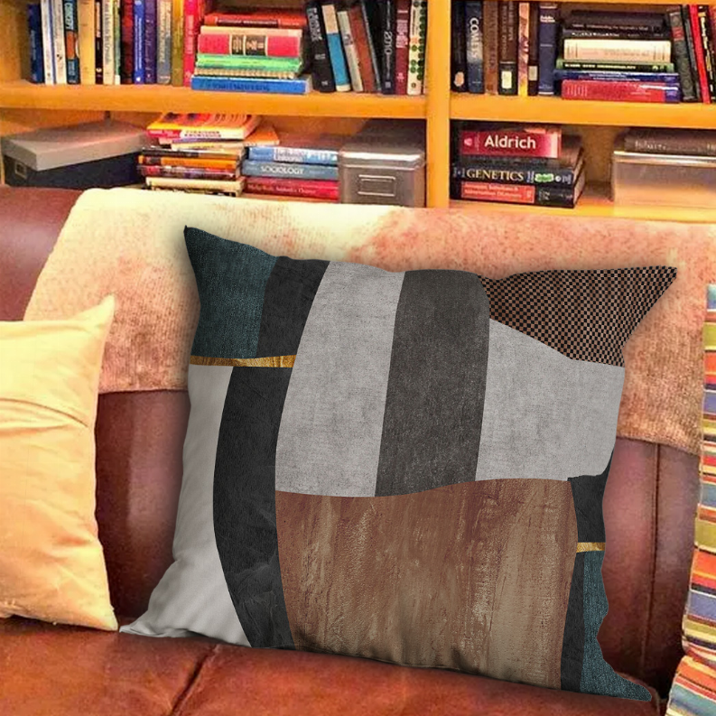 Decorative square pillow with geometric patchwork blocks in gray, teal, brown, and rust