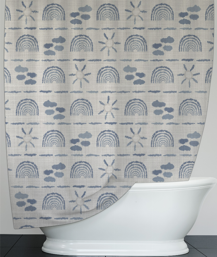 Light gray shower curtain with blue repeating rainbows, clouds, paw prints, and starbursts