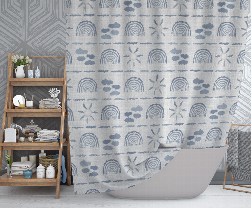 Shower curtain in light gray with blue rainbows, clouds, paw prints, and starburst motifs