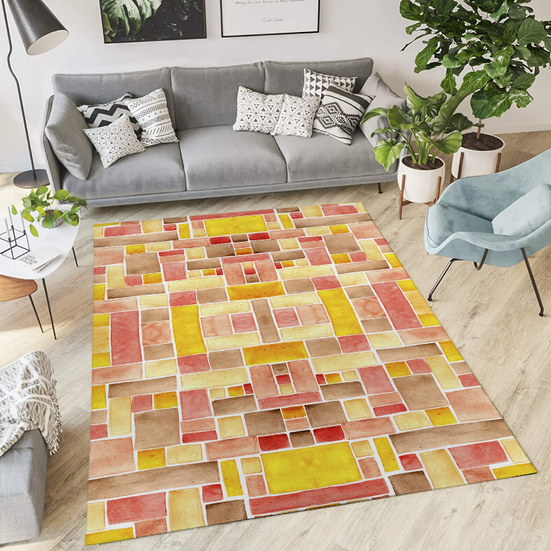 Multicolor low-pile rug laid flat with multitone tile grid in red, yellow, and tan.