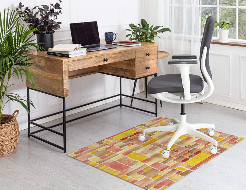 Multicolor low-pile carpet with repeating tile squares in red, yellow, orange, and tan.