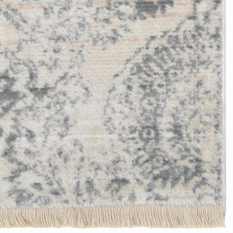 Cream and blue-gray distressed area rug with ornate medallion pattern and fringe