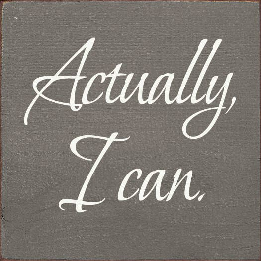 Gray wood sign with white cursive text: "Actually, I can."