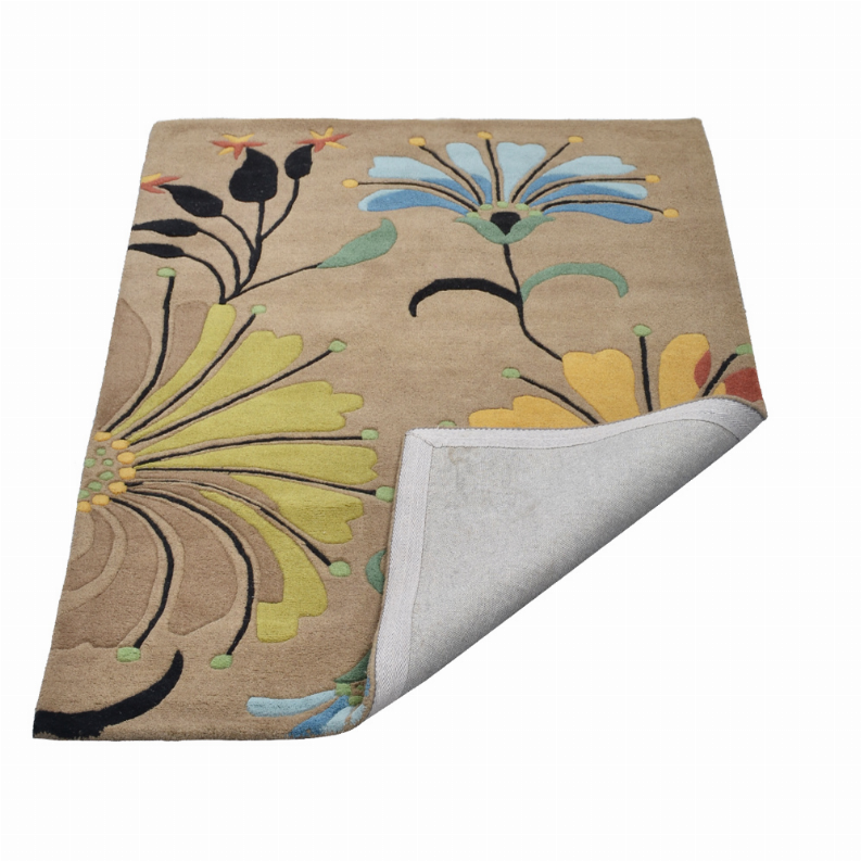 Floral hand-tufted wool area rug, beige with multicolor flowers; corner showing reverse backing