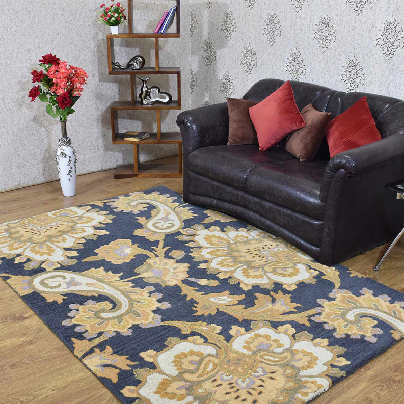 Hand-tufted wool area rug with navy and cream floral pattern on a living room floor