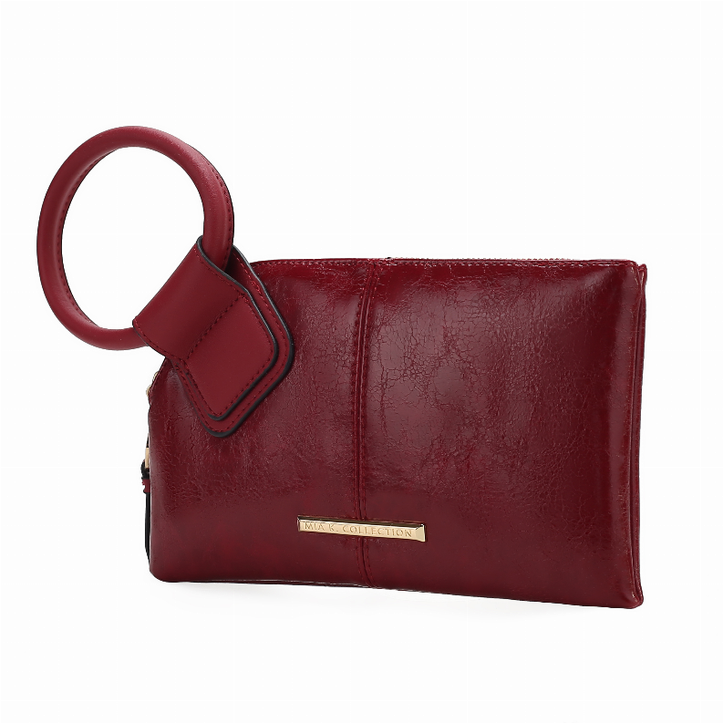 Red leather wristlet clutch with round ring handle and metal logo plate.
