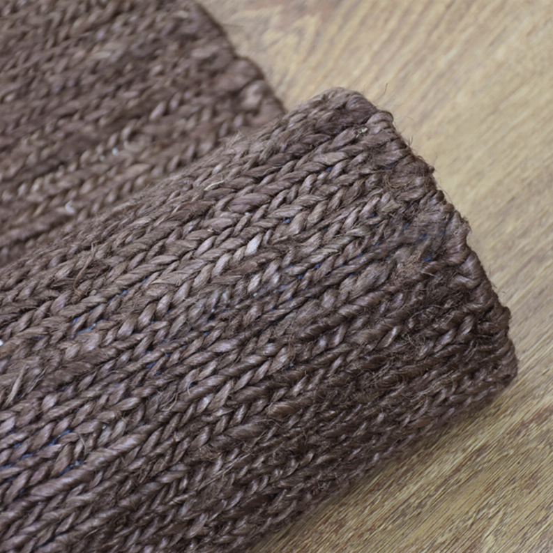 Brown jute area rug corner with dense woven border