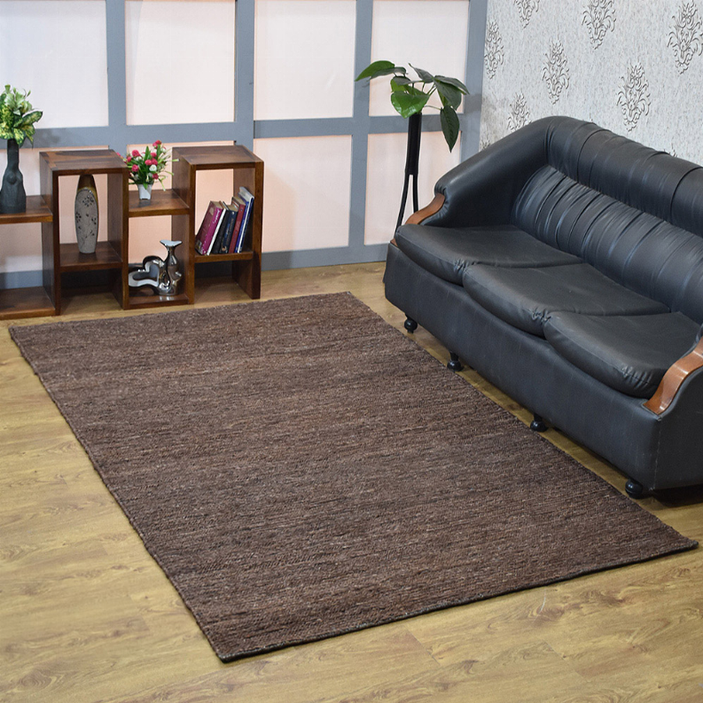 Brown jute area rug, flat solid design laid on wood floor