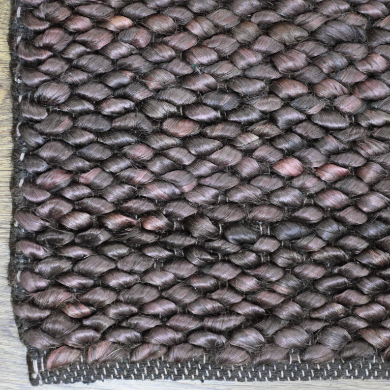 Hand-woven jute area rug with chunky solid weave in dark gray with muted rose flecks