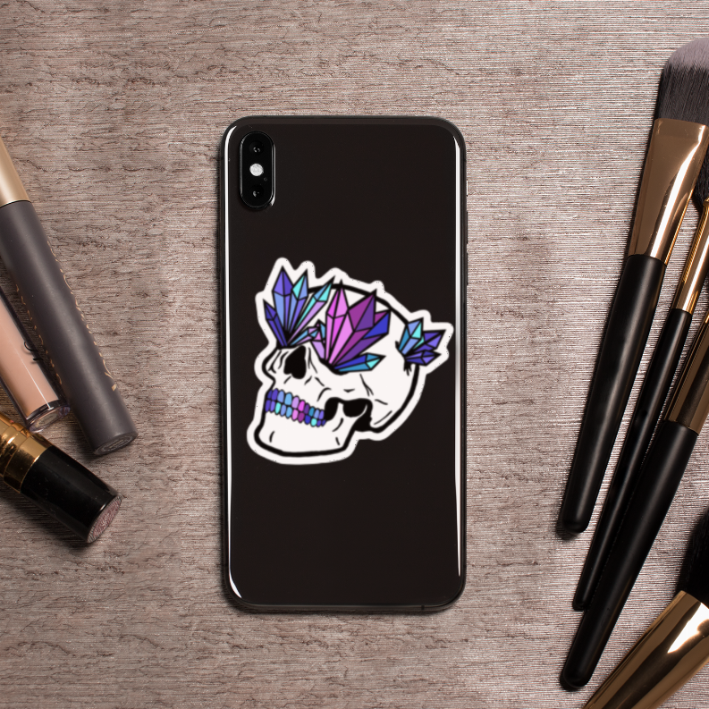 Crystal skull sticker centered on dark phone case, colorful crystal facets with white outline