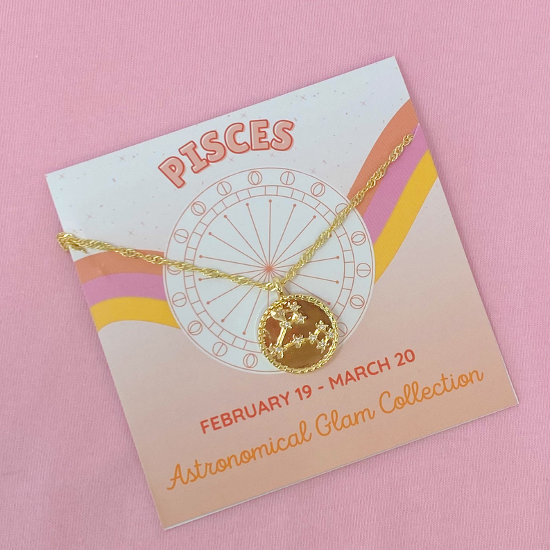 Pisces zodiac pendant necklace: gold chain with round starry charm shown on card