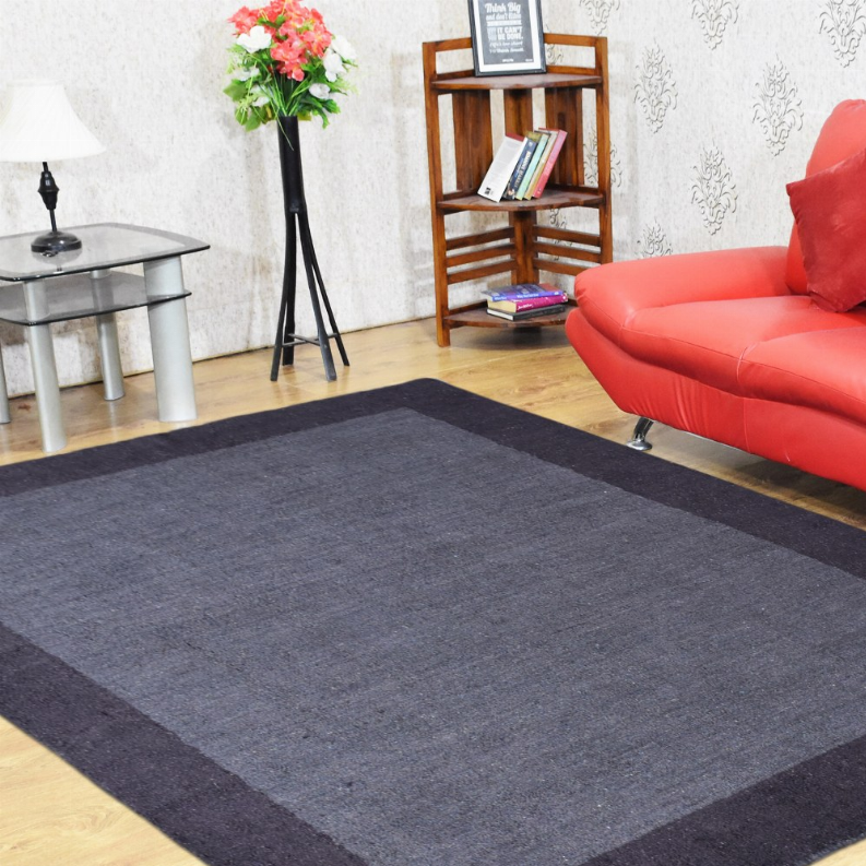 Dark gray area rug with darker border and lighter center panel, laid flat