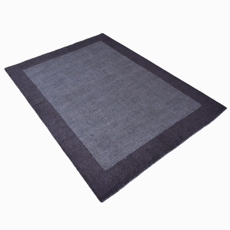 Navy-gray area rug with darker frame border and lighter center square, angled