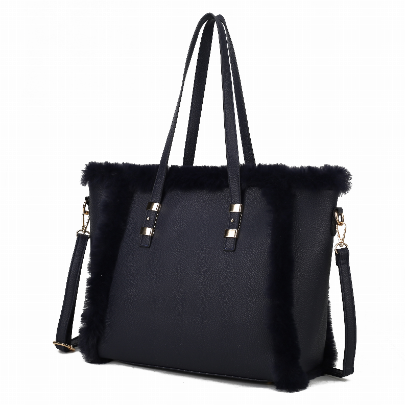 Dark faux fur–trim tote bag with vegan leather body, gold hardware, double handles.