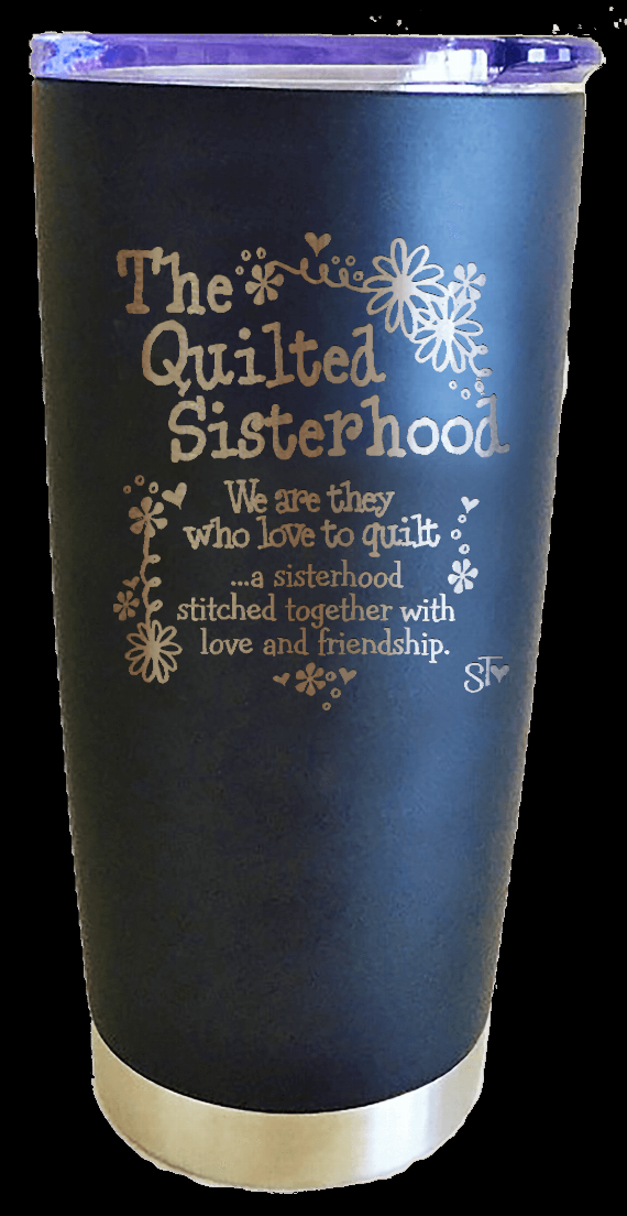 Blue-black tumbler with "The Quilted Sisterhood" design and beige bottom band