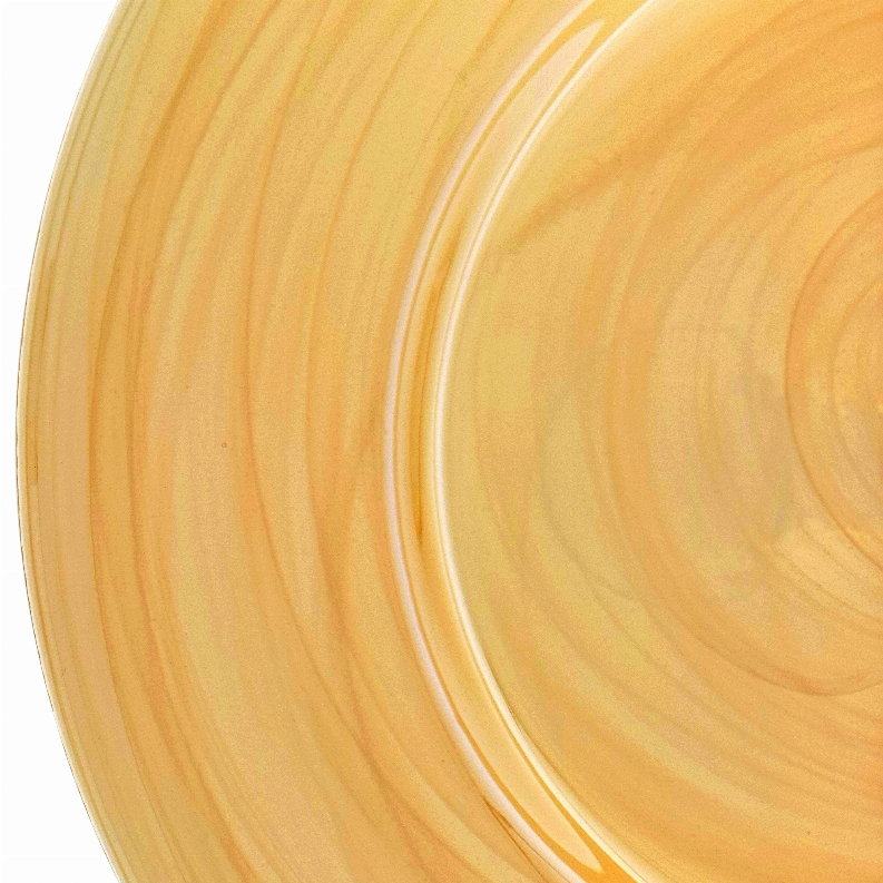 Amber glass charger plate close-up showing swirling grain and glossy curved rim
