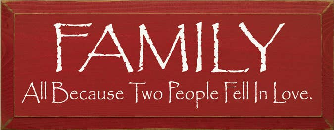 Red wood sign with white “FAMILY” and “All Because Two People Fell in Love” text
