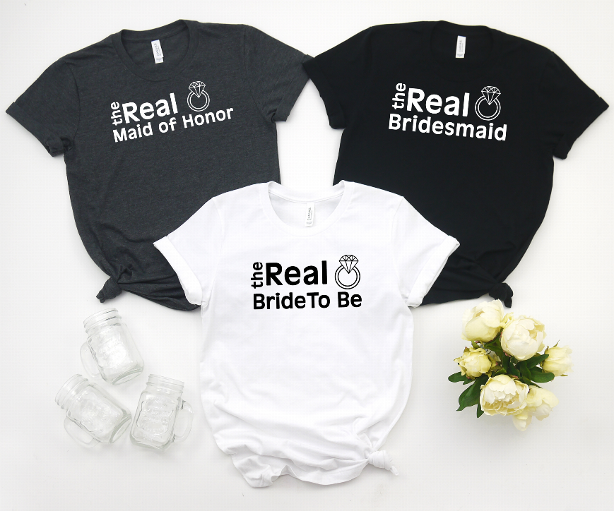Set of three short-sleeve T-shirts in dark and white, with 'the Real' role text