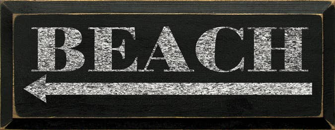 Dark wood beach sign with large white 'BEACH' lettering and banner arrow