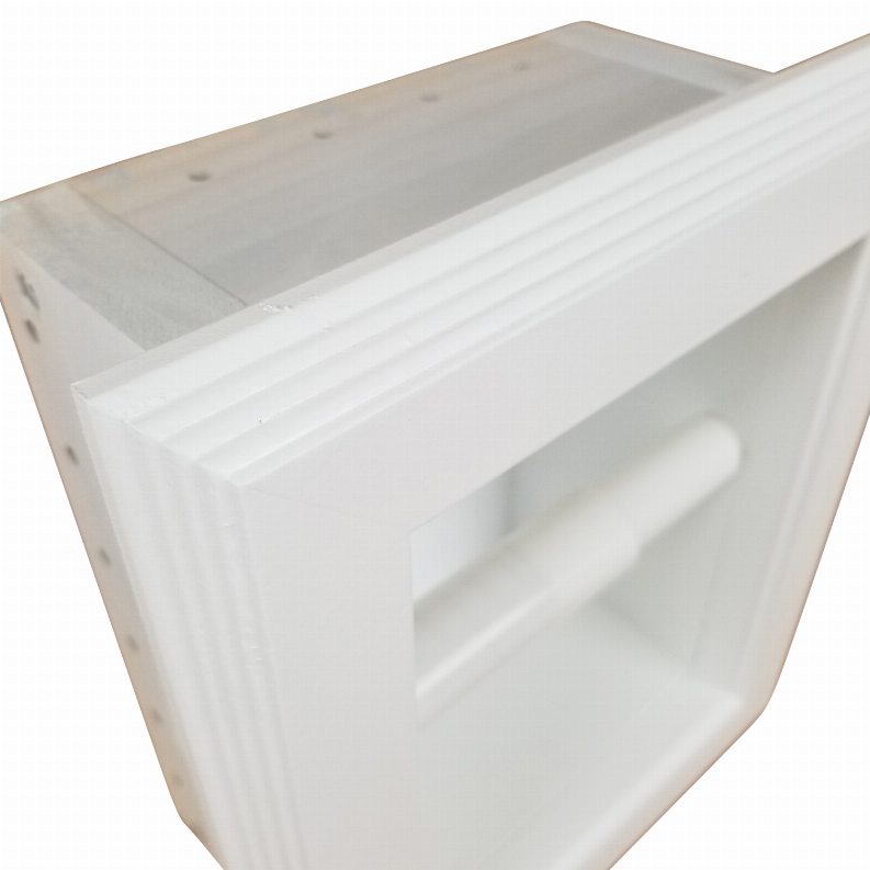 Recessed toilet paper holder close-up with white front opening and mounted roll