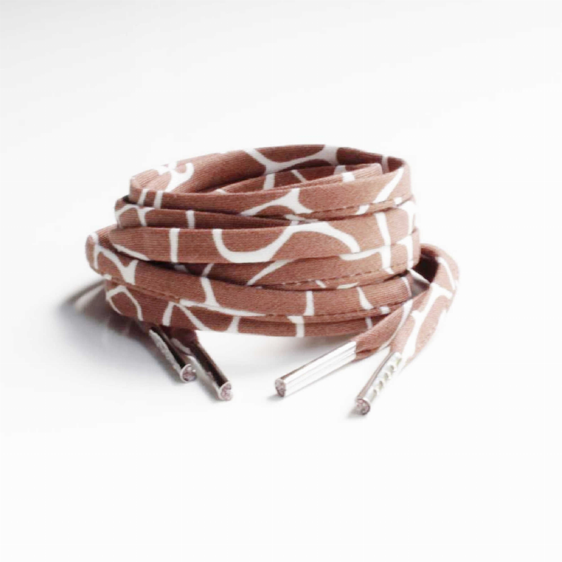 Brown and white giraffe-print shoelaces, bundled coil with loose tips.