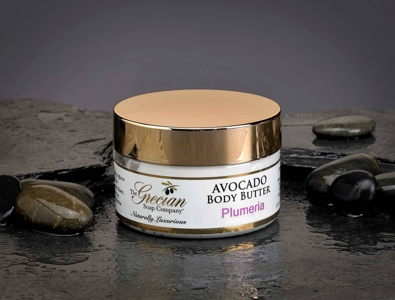 Body butter jar with gold lid, 'Plumeria' scent label.
