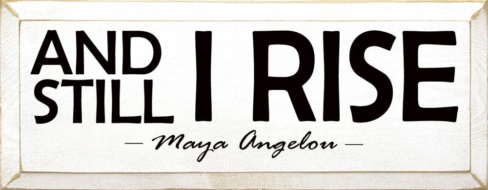 Wooden sign with 'AND STILL I RISE' and 'Maya Angelou' text, black lettering