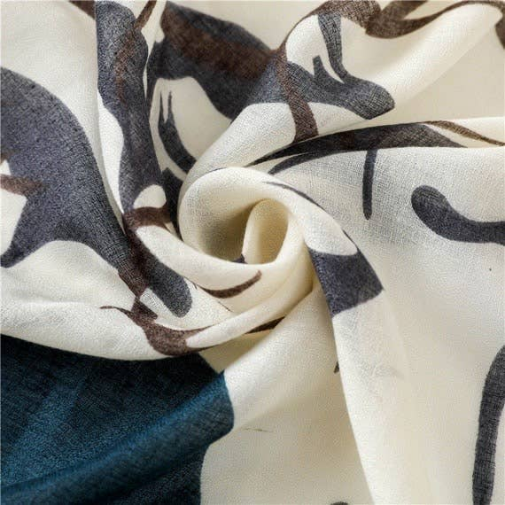Handmade scarf close-up, soft woven fabric with navy and tan animal print