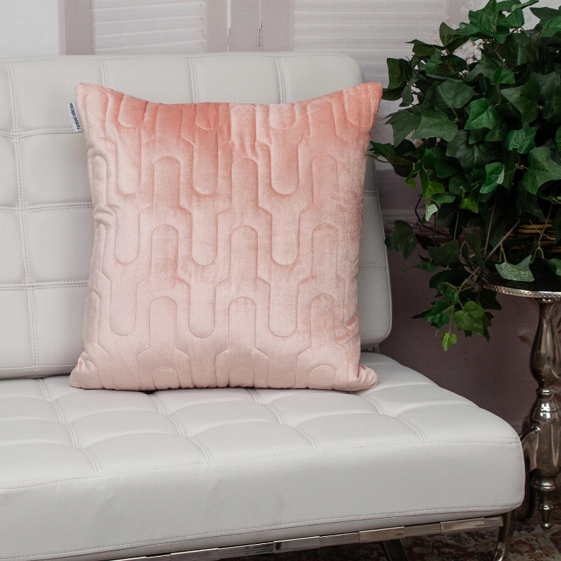 Pink quilted throw pillow with repeating arched stitch pattern