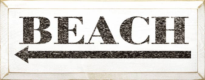 White beach wood sign with bold black “BEACH” text and arrow graphic