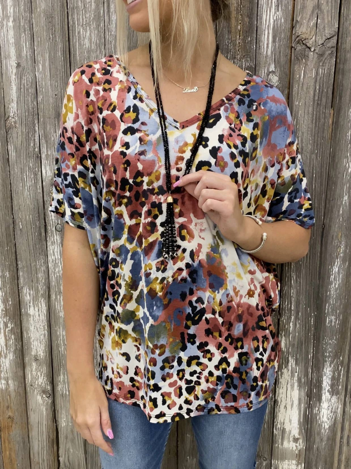 Women’s multicolor animal-print top with V-neck and black tie string at neckline