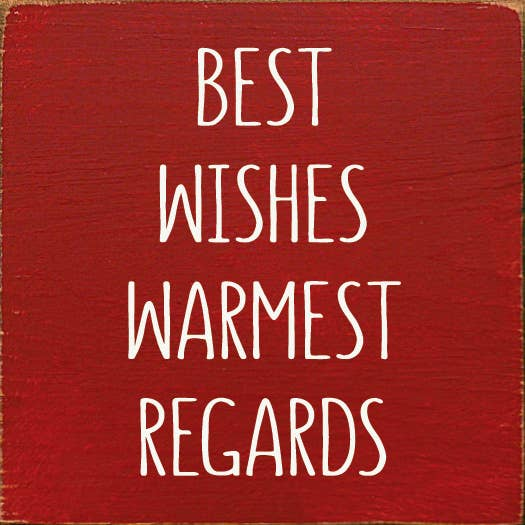 Red wood sign with white handwritten-style text: BEST WISHES WARMEST REGARDS