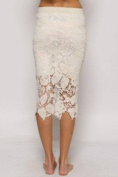 Off-white lace midi skirt with allover lace detail and mid-calf scalloped hem.