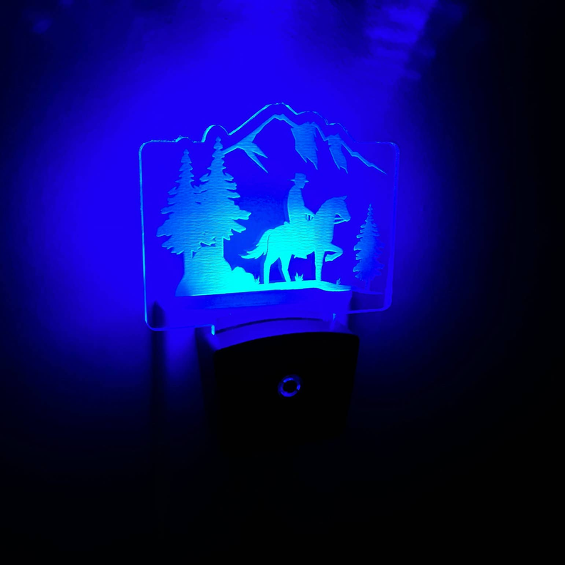 LED nightlight with blue cowboy-and-horse mountain scene over black base