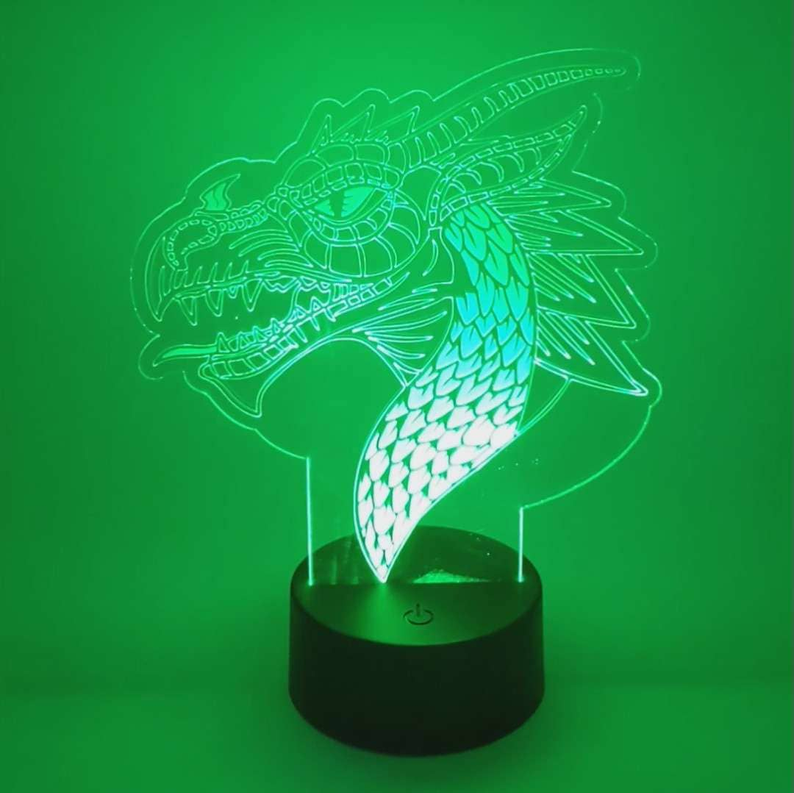Dragon LED lamp with glowing green acrylic dragon design on a black base