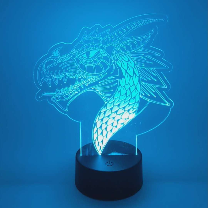 Dragon LED lamp with glowing blue acrylic dragon design on a black base