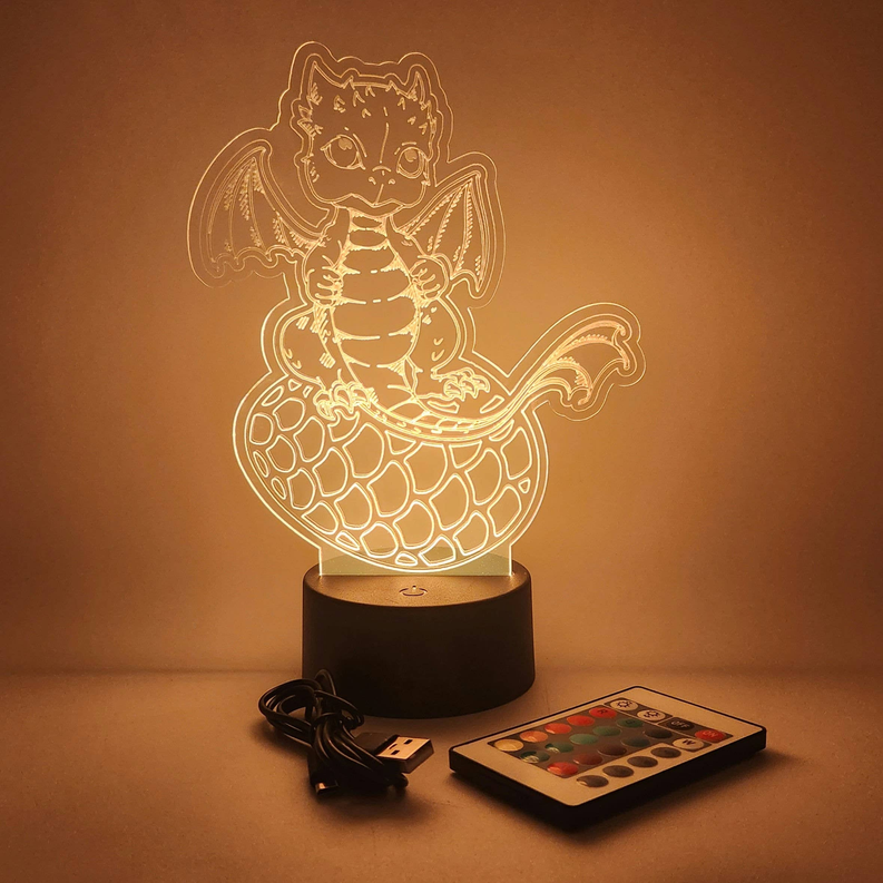 Baby dragon LED lamp with glowing outline on black base, includes USB cable and remote