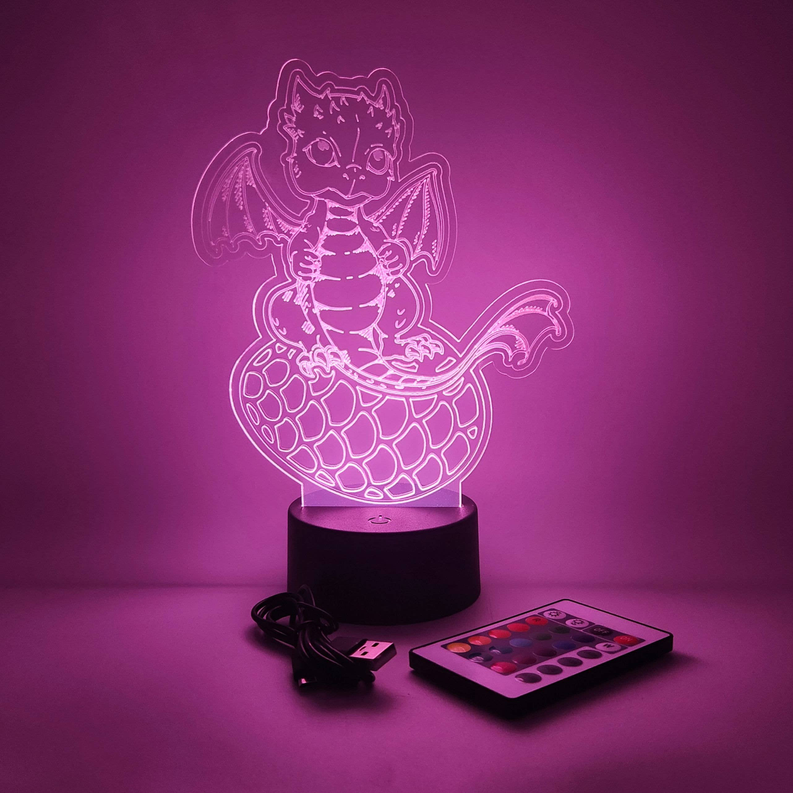 Baby dragon LED lamp with purple glow outline on black base, includes USB cable and remote