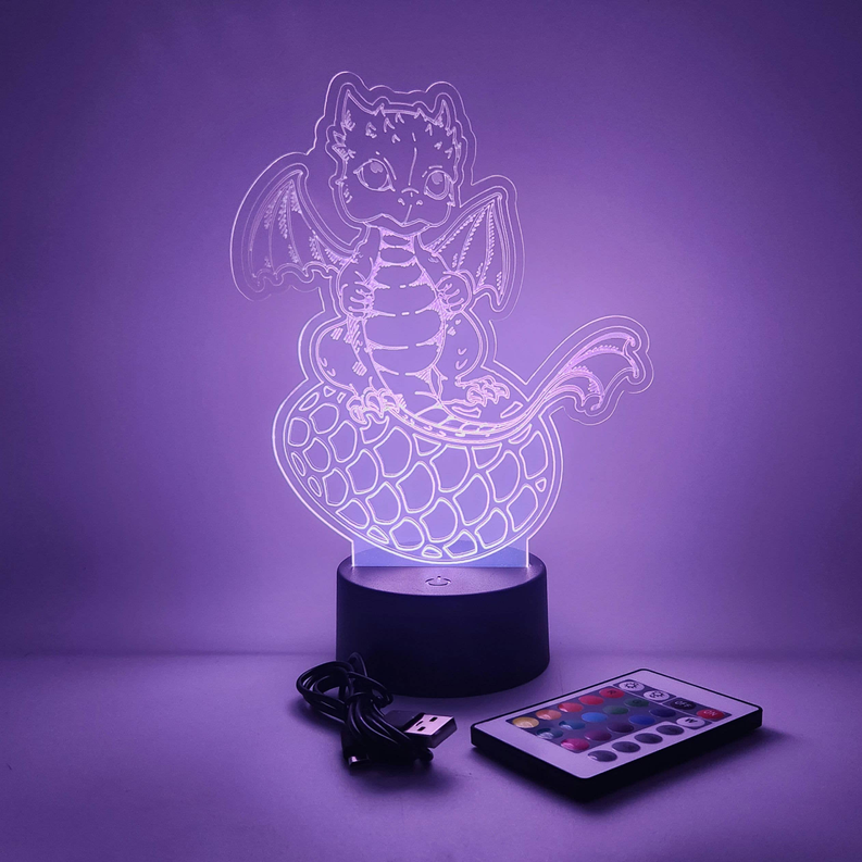 Baby dragon LED lamp with violet glow outline on black base, includes USB cable and remote