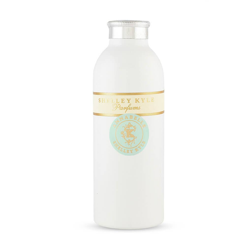 White bottle with silver cap and gold band label, teal seal centered on front