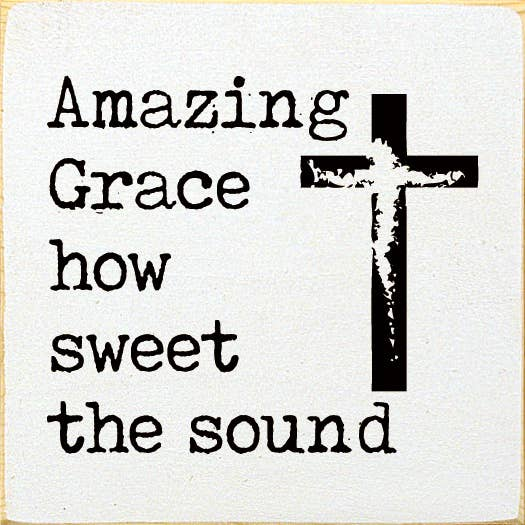 Decorative wall sign with black cross and hymn lyrics on white background